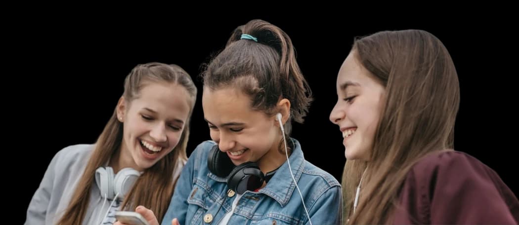Three friends listening to music together on a phone